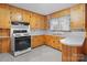 Efficient kitchen features wood cabinets, gas range, white countertop and sleek flooring at 1489 Riley St, Albemarle, NC 28001