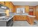 Charming kitchen with wood cabinets, white countertops, and modern gas range at 1489 Riley St, Albemarle, NC 28001