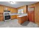 Functional kitchen with wood cabinets, white countertops, and a gas range at 1489 Riley St, Albemarle, NC 28001