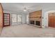 Living area with a brick fireplace, and natural light streaming through large windows at 1489 Riley St, Albemarle, NC 28001