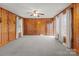 Bright and airy living room with wood paneling, neutral carpet, and natural light at 1489 Riley St, Albemarle, NC 28001