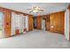 Open living room featuring wood paneling, plush carpet, and bright, natural light at 1489 Riley St, Albemarle, NC 28001