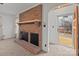 Cozy living room featuring a classic brick fireplace and doorway to the front of the home at 1489 Riley St, Albemarle, NC 28001
