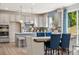 Modern eat-in kitchen with gray cabinets, stylish lighting, and a complementary backsplash at 1498 Hubert Graham Way, Tega Cay, SC 29708