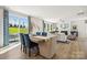 Bright living room with a dining area and a large sliding glass door leading to a porch at 1498 Hubert Graham Way, Tega Cay, SC 29708
