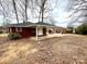 A backyard featuring a covered patio area and a well-maintained lawn at 1936 Russell Ave, Charlotte, NC 28216