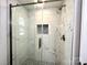 Modern bathroom showcasing a glass shower with marble-style tile and elegant fixtures at 1936 Russell Ave, Charlotte, NC 28216