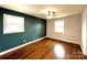 Inviting bedroom with hardwood floors, neutral walls, and a modern ceiling fan at 1936 Russell Ave, Charlotte, NC 28216