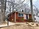 Charming brick home with a well-manicured front yard and inviting blue front door at 1936 Russell Ave, Charlotte, NC 28216