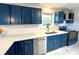 Modern kitchen with white countertops, stainless steel appliances, and stylish blue cabinets at 1936 Russell Ave, Charlotte, NC 28216