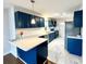 Updated kitchen features modern countertops, stylish blue cabinetry, and stainless steel appliances at 1936 Russell Ave, Charlotte, NC 28216
