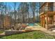 Beautiful backyard featuring a pool, spa, stone patio, firepit and a wooded backdrop at 2013 Gladelynn Ct # 354, Belmont, NC 28012