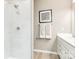 Modern bathroom featuring a walk-in shower with white tiling, white cabinets, and modern fixtures at 2132 Primm Farms Dr, Charlotte, NC 28216