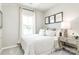 Cozy bedroom featuring a comfortable bed with decorative pillows, side table and natural light at 2132 Primm Farms Dr, Charlotte, NC 28216