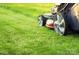 Close-up of a lawn mower on a well-maintained lawn, showing property upkeep at 2132 Primm Farms Dr, Charlotte, NC 28216