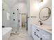 Bright bathroom with a glass shower and a modern bathtub, complete with double vanity and stone countertops at 2143 Country Club Rd, Lincolnton, NC 28092