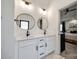 Bright bathroom features double vanity with stone countertops, round mirrors, and views into the bedroom at 2143 Country Club Rd, Lincolnton, NC 28092