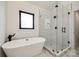 Bright bathroom features a modern bathtub and a glass shower, complete with black fixtures at 2143 Country Club Rd, Lincolnton, NC 28092
