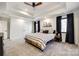 Spacious bedroom with a tray ceiling, carpet floors, and a bed with a black and white striped comforter at 2143 Country Club Rd, Lincolnton, NC 28092