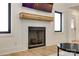 Modern fireplace with a wooden mantle, a black firebox, and windows flanking the side at 2143 Country Club Rd, Lincolnton, NC 28092