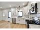 Bright modern kitchen featuring white cabinets, stainless steel appliances, and hardwood floors at 2143 Country Club Rd, Lincolnton, NC 28092