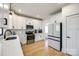 Modern kitchen with white cabinets, stainless steel appliances, and hardwood floors at 2143 Country Club Rd, Lincolnton, NC 28092