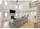 Open concept living room with high ceilings, fireplace, and view into the modern kitchen at 2143 Country Club Rd, Lincolnton, NC 28092