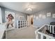 This is a bedroom with carpet flooring, a ceiling fan, and a Moana wall decal near a shelving unit at 226 Belfield Ln, Fort Mill, SC 29715