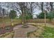 Backyard features a stone fire pit, lush landscaping, and a privacy fence at 3126 Creighton Dr, Charlotte, NC 28205