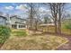 Landscaped backyard featuring a stone fire pit and privacy fence at 3126 Creighton Dr, Charlotte, NC 28205