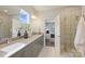 Bright bathroom featuring double sinks, modern cabinets, a large mirror, and a walk-in shower at 3126 Creighton Dr, Charlotte, NC 28205