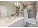 Modern bathroom with double sinks, sleek gray tile, recessed lighting, and updated fixtures at 3126 Creighton Dr, Charlotte, NC 28205