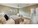 Bedroom with a large bed, ceiling fan, and natural light from three windows at 3126 Creighton Dr, Charlotte, NC 28205