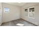 Minimal bedroom featuring modern gray wood flooring and plenty of natural light through updated windows at 3126 Creighton Dr, Charlotte, NC 28205