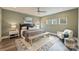 Bright bedroom with a ceiling fan, large bed, and natural light from three windows at 3126 Creighton Dr, Charlotte, NC 28205