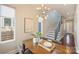 Bright dining area featuring a modern chandelier, large windows, and easy access to the stairs at 3126 Creighton Dr, Charlotte, NC 28205