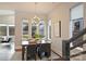 Charming dining area featuring a modern chandelier, large windows, and views of the backyard at 3126 Creighton Dr, Charlotte, NC 28205