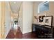 Inviting hallway with dark floors, a decorative console table, and a glimpse into the dining area at 3126 Creighton Dr, Charlotte, NC 28205