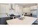Modern kitchen features two-tone cabinetry, stainless steel appliances, and a spacious island with a sink at 3126 Creighton Dr, Charlotte, NC 28205