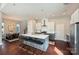 Open-concept kitchen with large island featuring bar seating, stainless appliances, and modern lighting at 3126 Creighton Dr, Charlotte, NC 28205