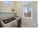 Bright laundry room featuring a side-by-side washer and dryer and a large sunny window at 3126 Creighton Dr, Charlotte, NC 28205