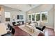 Living room with large windows, contemporary furniture, and an open floor plan with vaulted ceilings at 3126 Creighton Dr, Charlotte, NC 28205