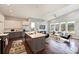 Open-concept living space with kitchen, island, and a living room with large windows and modern furnishings at 3126 Creighton Dr, Charlotte, NC 28205