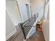 View down modern gray and white staircase with views to dining room at 3126 Creighton Dr, Charlotte, NC 28205