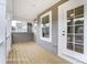Charming back porch with wood flooring, gray siding, and a white door, perfect for relaxing outdoors at 3213 Mcharney Dr # 32, Harrisburg, NC 28075