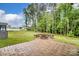 Enjoy the outdoor paver patio with a built-in firepit, perfect for entertaining in the landscaped backyard at 3213 Mcharney Dr # 32, Harrisburg, NC 28075