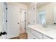 Bright bathroom with wood-look flooring, white cabinets, and a large framed mirror at 3213 Mcharney Dr # 32, Harrisburg, NC 28075