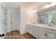 Bright bathroom featuring a double vanity, framed mirror, and spacious glass enclosed shower with marble-style tiling at 3213 Mcharney Dr # 32, Harrisburg, NC 28075