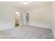Bedroom featuring neutral walls and carpet, with an ensuite bathroom, and a doorway to the staircase at 3213 Mcharney Dr # 32, Harrisburg, NC 28075