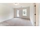 Bedroom featuring carpet flooring, neutral walls, and large windows creating a bright and welcoming atmosphere at 3213 Mcharney Dr # 32, Harrisburg, NC 28075